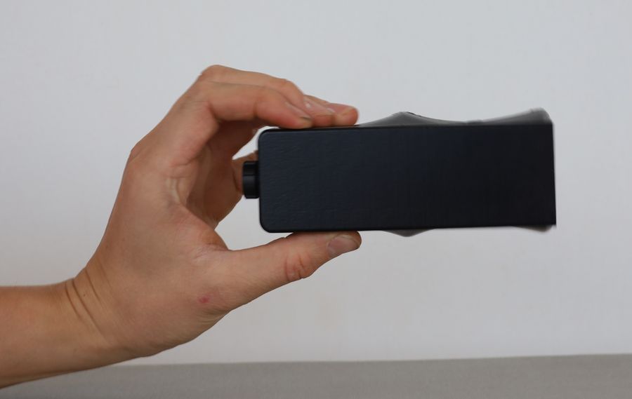 The DiscoX held head on with its flat front face towards the camera, showing the shallow depth of the case.